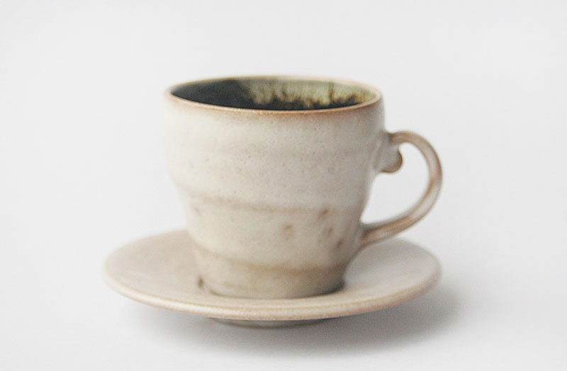 Tea cup and saucer - wheel thrown with shino glaze