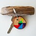 Pine wood keychain with stainless steel cable wire, tones of yellow, blue, red, orange, black geometric triangle shapes