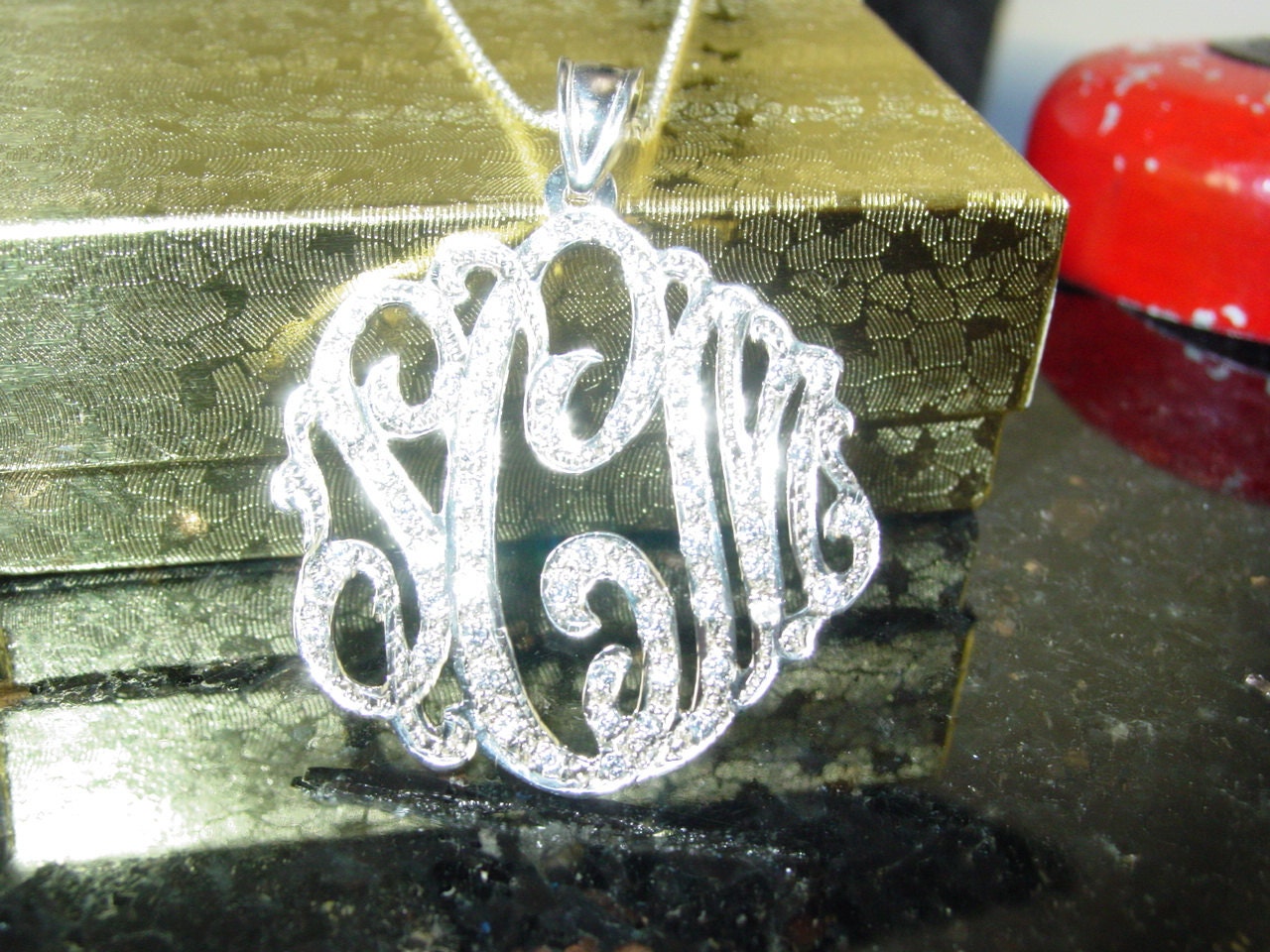sterling silver monogram necklace 1.25" size ,  with 60cz pave' set. With a chain .