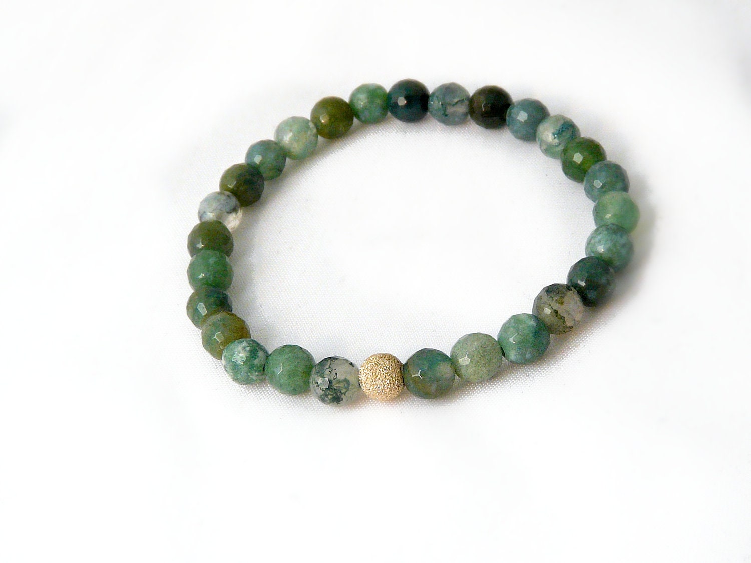 moss agate bracelet with gold focal bead. small stacking yoga stretch bracelet in green, teal, olive and aquamarine.