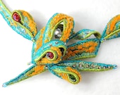 Textile neckpiece in turquoise, green and orange