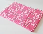iPad padded gadget pouch: Abstract square and triangle print in white and pink with flap.