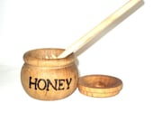 Miniature wooden honey pot and honey dipper.
