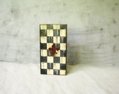 Container Poppy red  Checked vampire gothic style black, red, white, ivory oblong box with the blood red Lily on top
