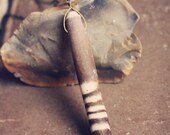 sea. an elegant sea bean necklace.