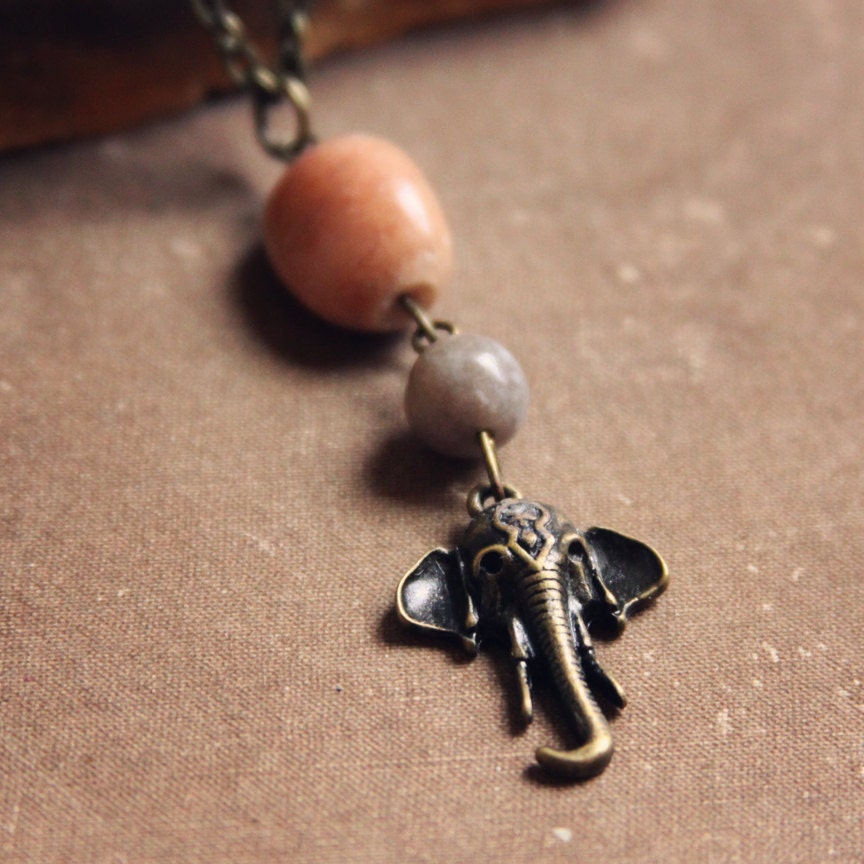 tiva.  a simple earthy polished stone and elephant charm necklace.