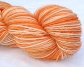 Variegated worsted yarn, hand dyed in "Orange Sea Star"