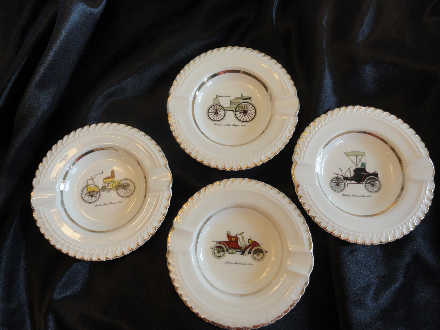 Set of four ceramic vintage ashtrays for men decor. Have old 1900s cars on them.Metallic gold trims