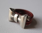 Leather ring. Red leather and metal bow ring.