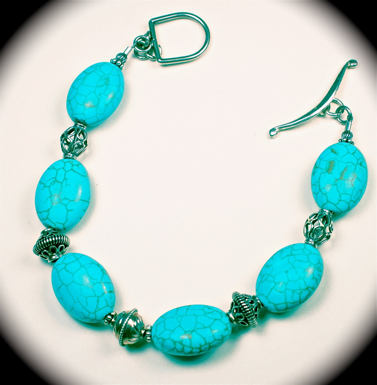 Lovely turquoise colored magnesite stones and sterling silver beaded bracelet.