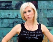 Don't Look Back, You're Not Going That Way done in vintage looking silk screen on a black workout tank with a ruffle trim
