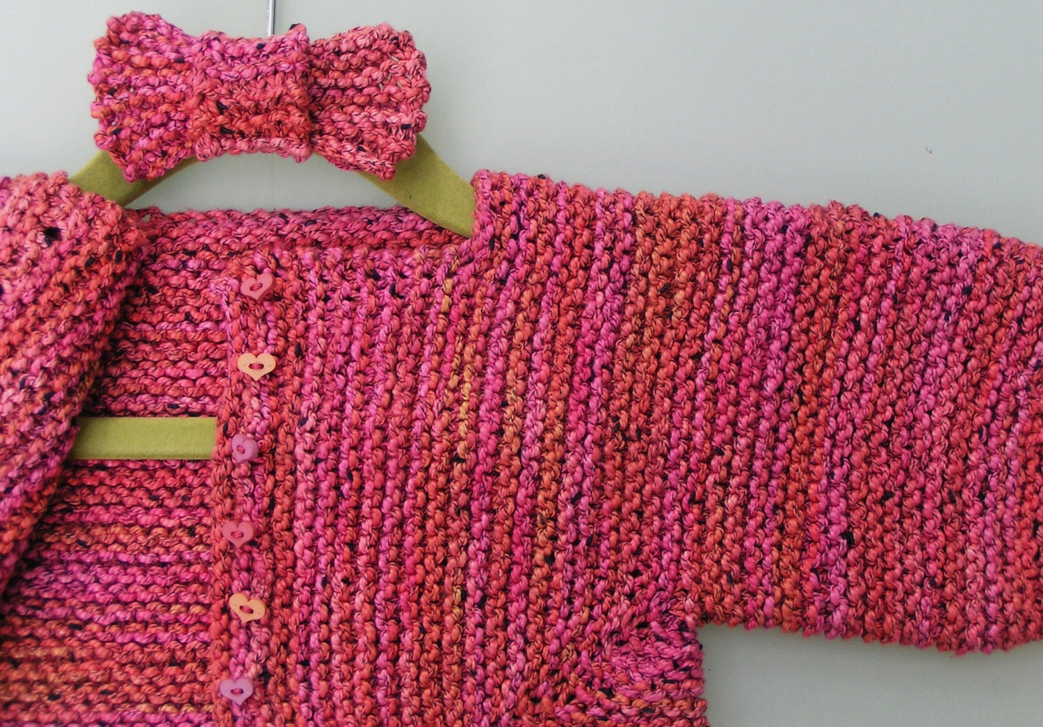 Baby"s Surprise Jacket (BSJ) and bow for headband: knitted in Araucania's cotton yarn, for toddlers' aged  9 to 12 months
