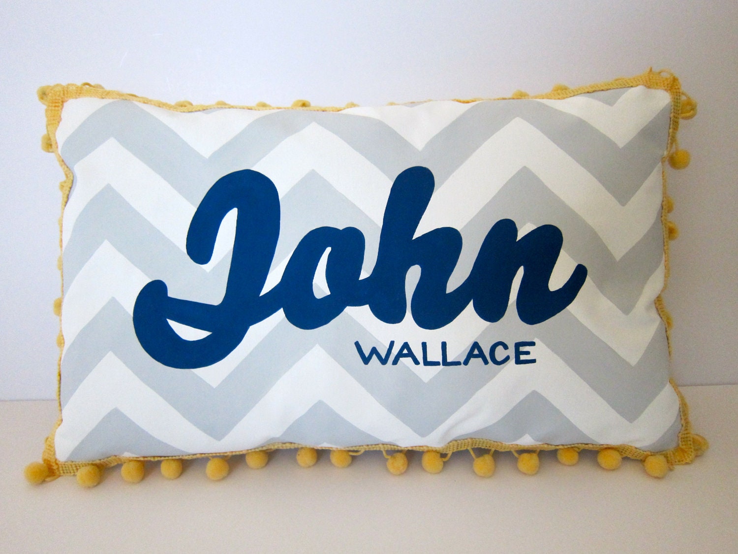 Baby pillow in light gray chevron and navy blue script. Personalized with name.
