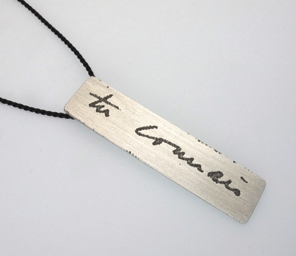 Manu Scriptum pendent on black silk