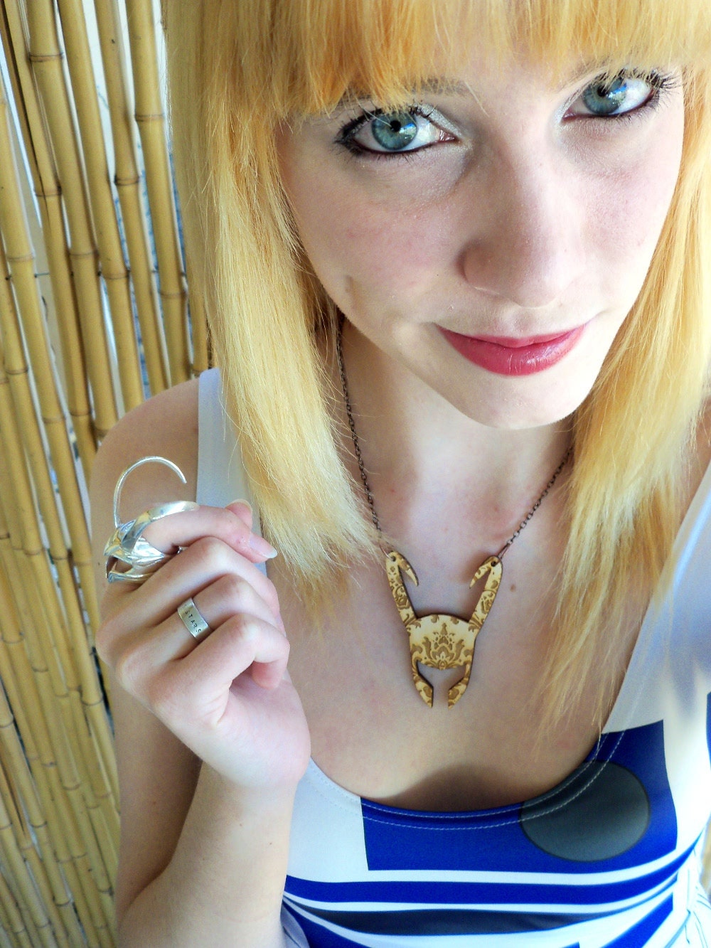 Patterned Loki helmet necklace.