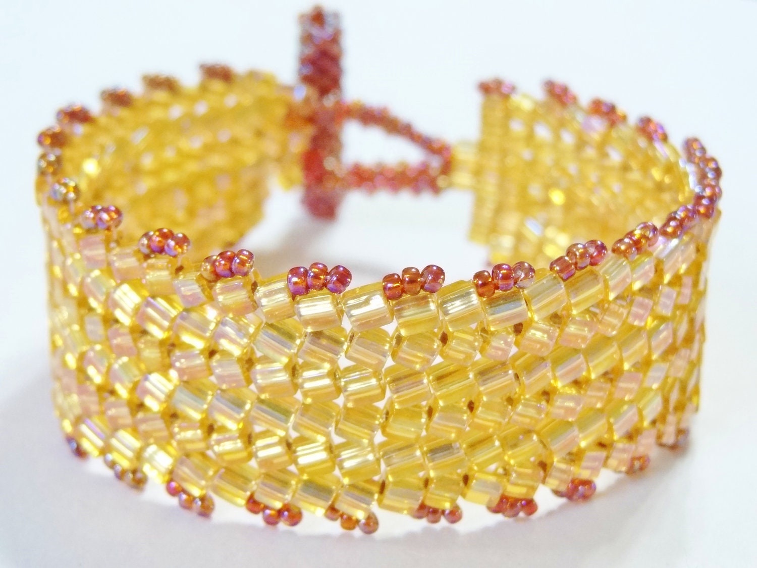 Athena: A bead woven flat herringbone stitch bracelet made with shimmering cube beads