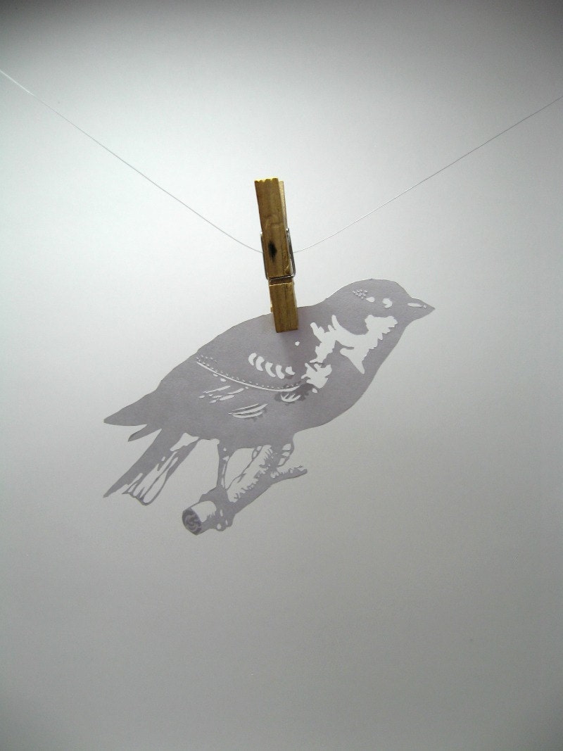 Paper-cut Scherenschnitte silhouette Finch on a Twig in Snow White