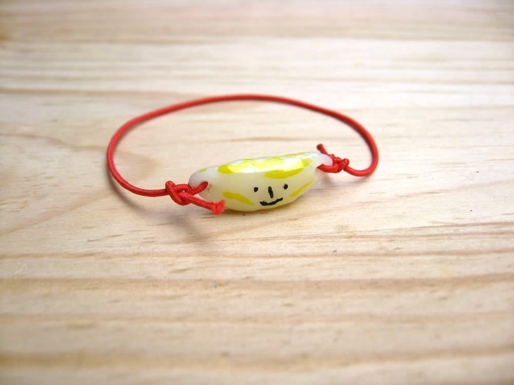 Bracelet with red elastic trim. Fruits. Porcelain charms. Pineapple, Strawberry and Banana.