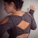 Bow Back Peplum Top with Cut Out Shoulders and Thumb Hole Sleeves