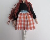 Beth, ooak small art doll with deep red hair, a black woolen jumper and a vintage gingham skirt.