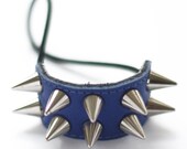 Handmade navy blue leather hair elastic with golden or silver min cone spikes.
