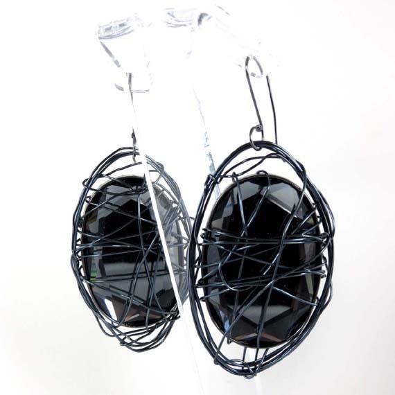 Stylish, modern, oversize shiny black earrings. Wire abracadabra style. Fashionably designed in Fashion Brand Faina studio.