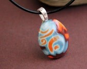 Fantasy pebble.  Glass like polymer clay pendant.  Mokume gane. Blue orange pearl brown.