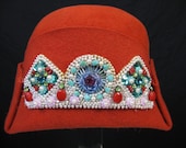 1920's orange felt beaded cloche hat. art deco fold hat with intricate beading. kimball usa.