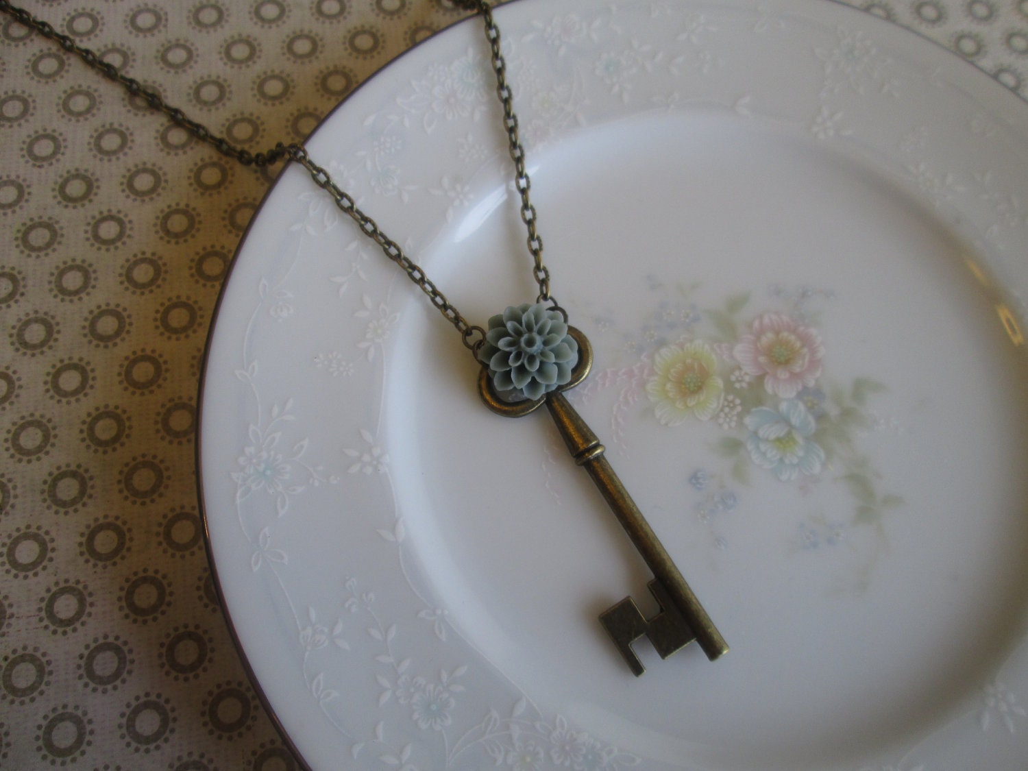 Unlocked Collection: Vintage-Style Skeleton Key Charm Necklace, Dusty Sage Dahlia Flower Decoration, Antique Bronze Tone.