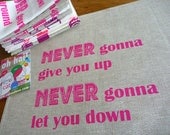 Never Gonna Give You Up tea towel in Pink on Natural