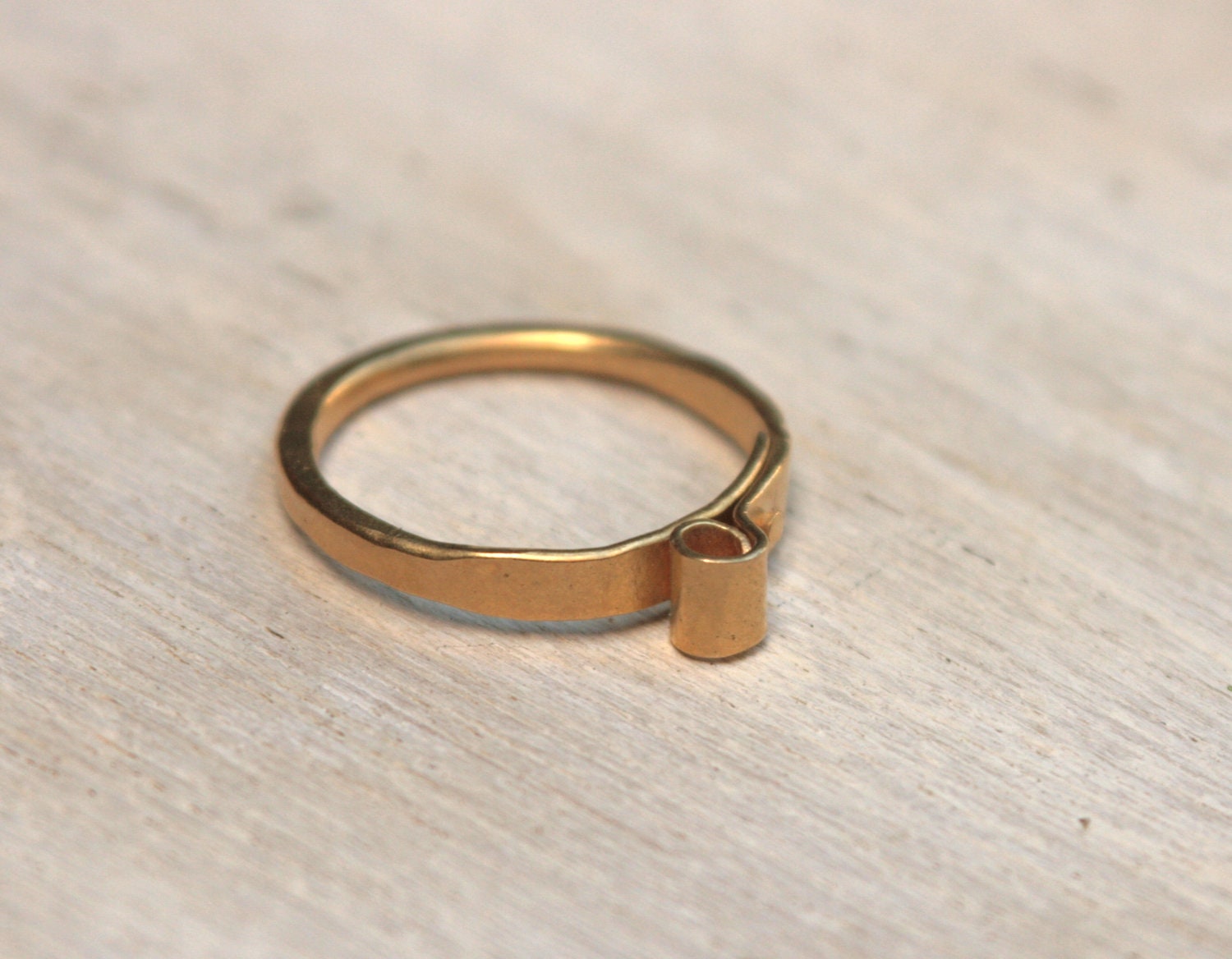18k gold plated sterling silver with a curled decoration on top. unique hammered ring. hand made.