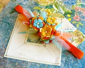 Flowered headband adorned with freshwater pearls and feathers.