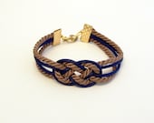 Brown and navy blue knotted nautical rope bracelet with gold anchor charm
