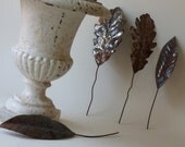 four vintage rusty tin leaves