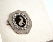 Hare silhouette shield brooch on felt