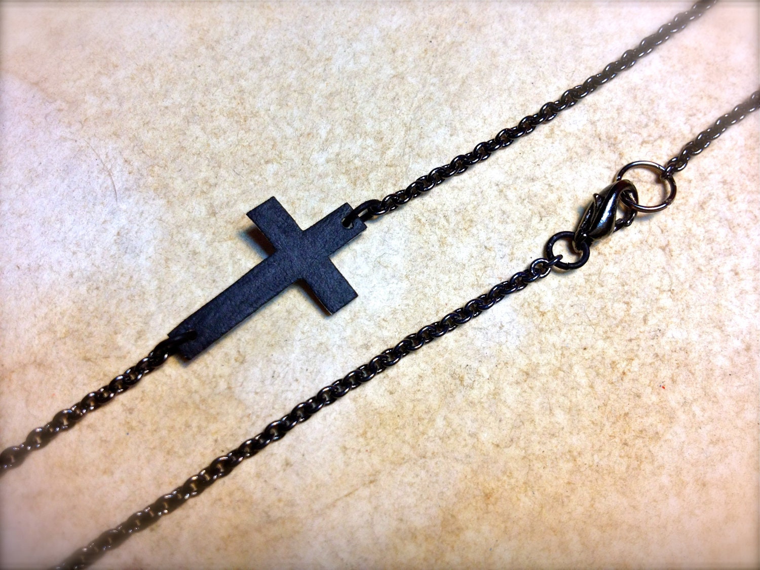 tiny dark sideways cross necklace with black chain