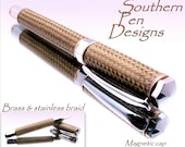 Supreme  rollerball pen in chrome with gold accents and  hand cast brass and stainless braid.