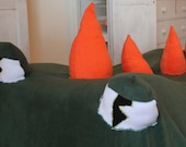 Dark green fleece Monster blanket with orange spikes and eyes, cozy and scary