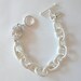 Silver link chain bracelet with crystal pave skull charm