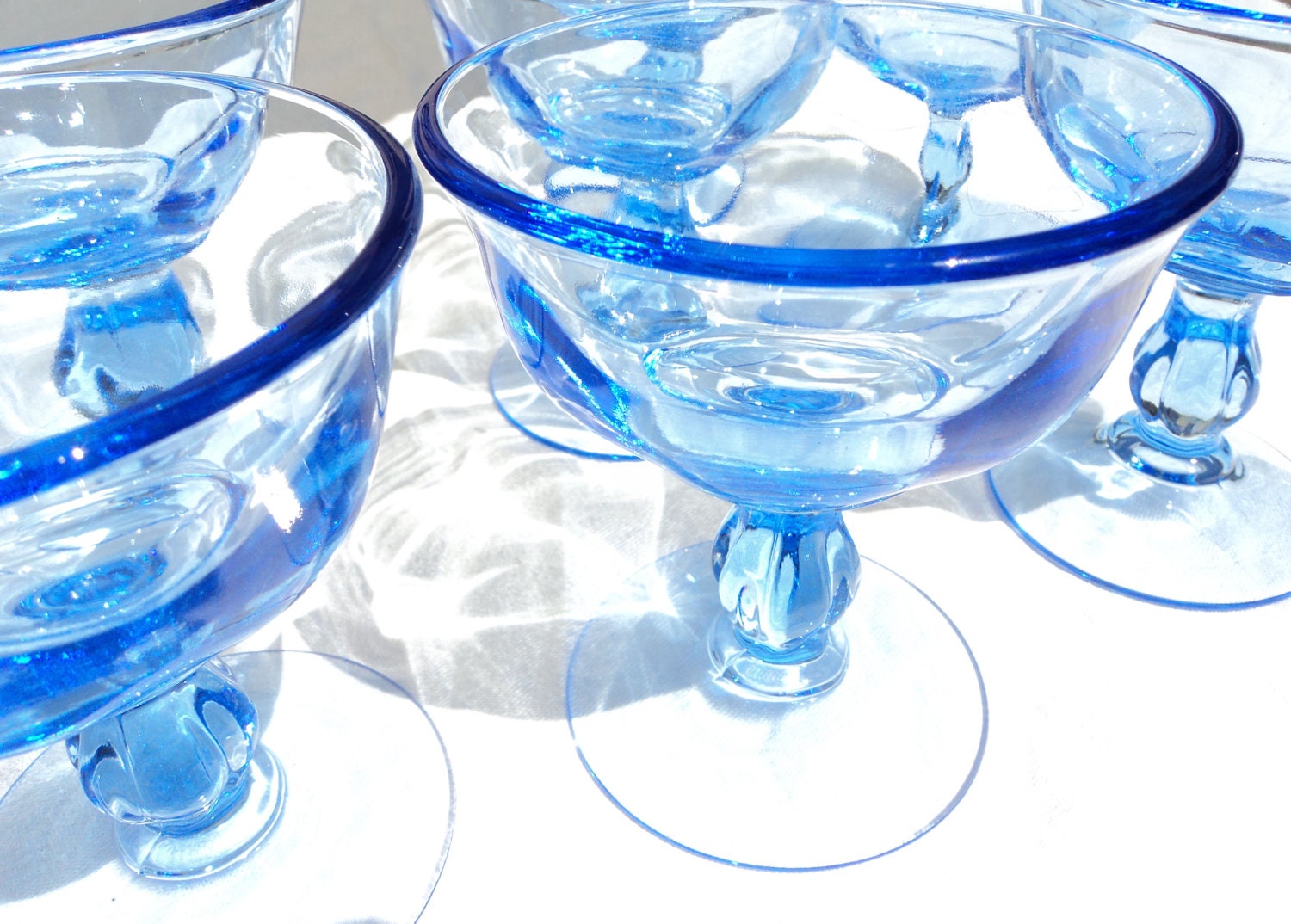 7 blue glass footed dessert bowls
