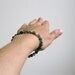 moss agate bracelet with gold focal bead. small stacking yoga stretch bracelet in green, teal, olive and aquamarine.