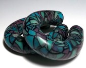 Gauged earrings, 1/2" plugs for stretched ears.  Stained glass horseshoe hoops, black grout and dark base. Polymer clay plugs.