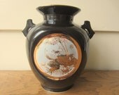 Gold and black vase.  Pheasant adorned black vase.