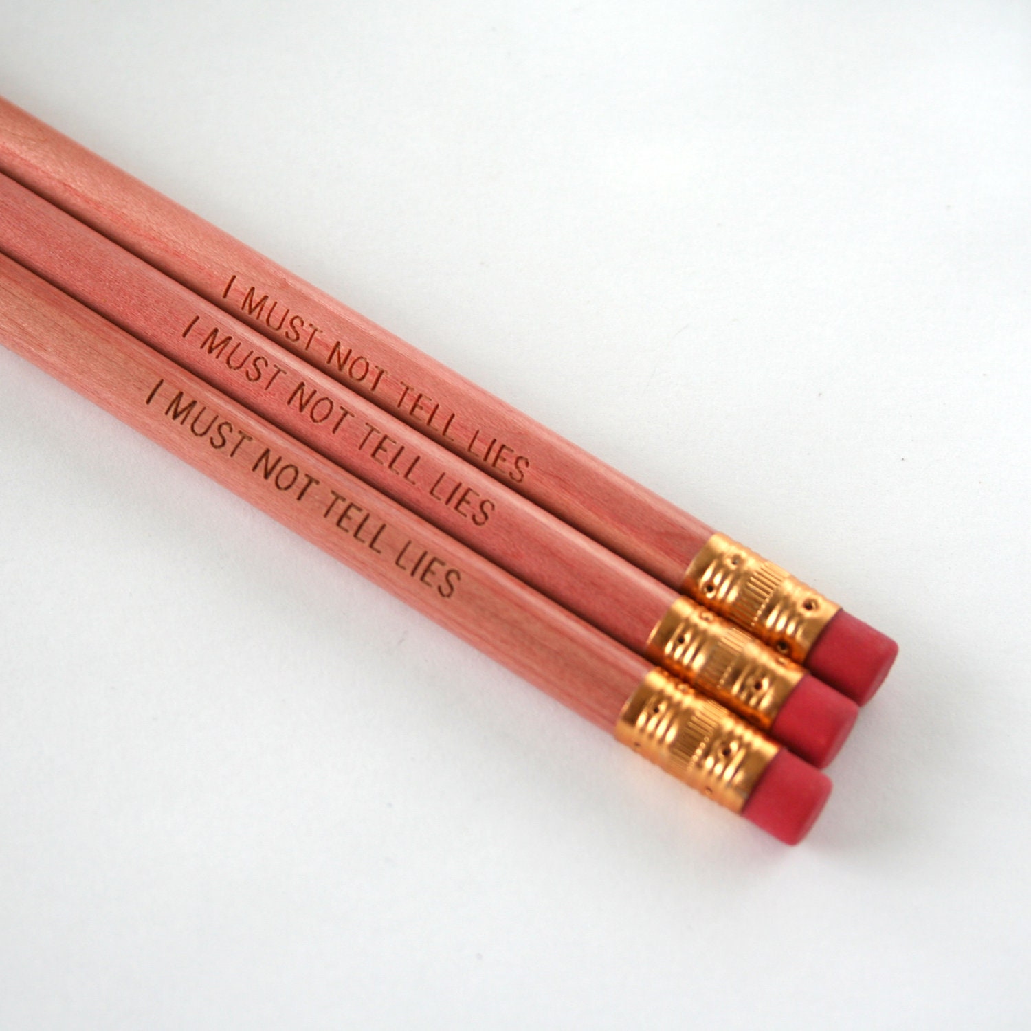 i must not tell lies pencil set of three 3 in natural wood. Wood color will be lighter than pictured.