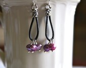 Earrings made sterling silver crimp ends, black greek leather and wire wrapped purple freshwater pearls
