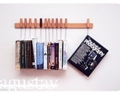 Custom made wooden book rack in Beech. Pins also work as bookmarks.