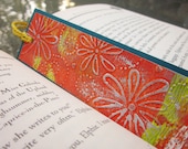 SIlver flower bookmark with orange and bright green background, embossed with blue border