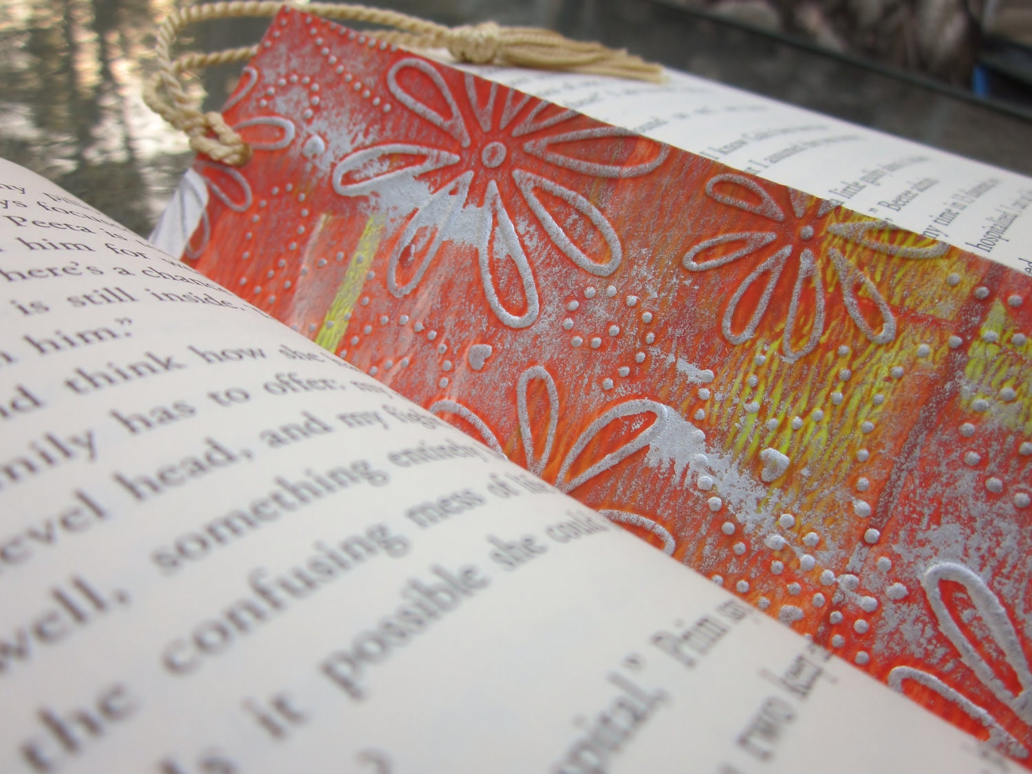 Embossed flower bookmark with orange and bright green background with gold tassel