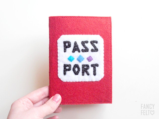 Red felt passport case with inscription