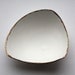 Stoneware fine bone china bowl with 10% real gold resembles a small boat.